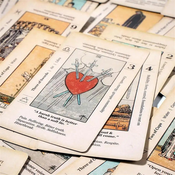 A close-up of an antiqued tarot card showing the Three of Swords card with a heart and arrows.