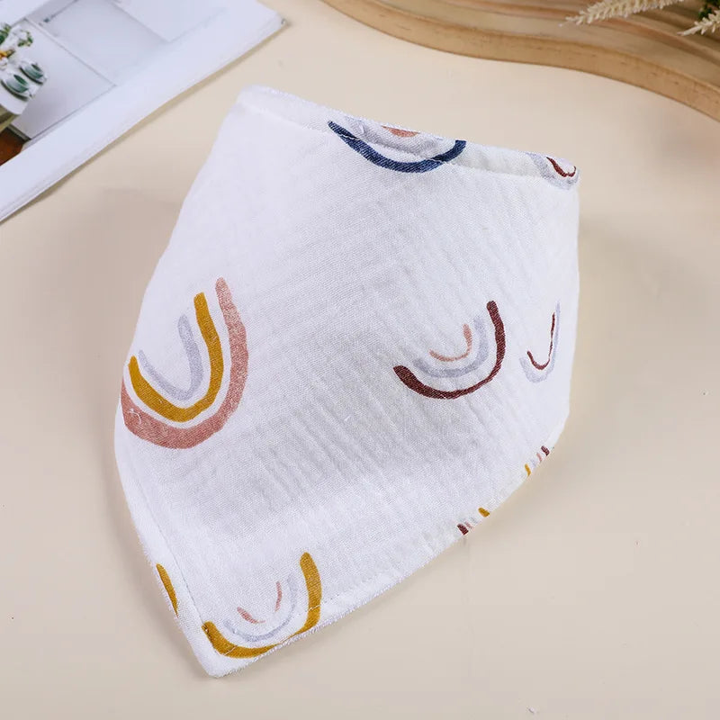 White soft cotton baby bib with colorful rainbow designs shown on a light background.