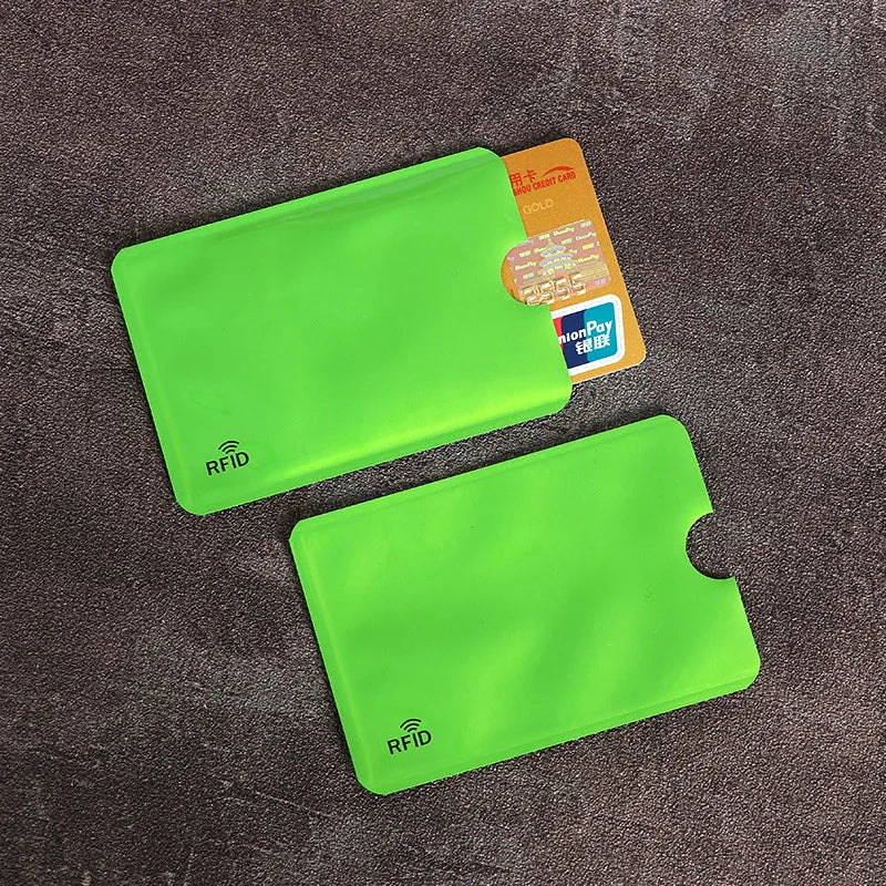 A bright lime green RFID blocking card sleeve is shown next to an orange ID card.
