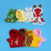 A set of adorable plush robot outfits featuring yellow, white, and red colors with ears and bows.