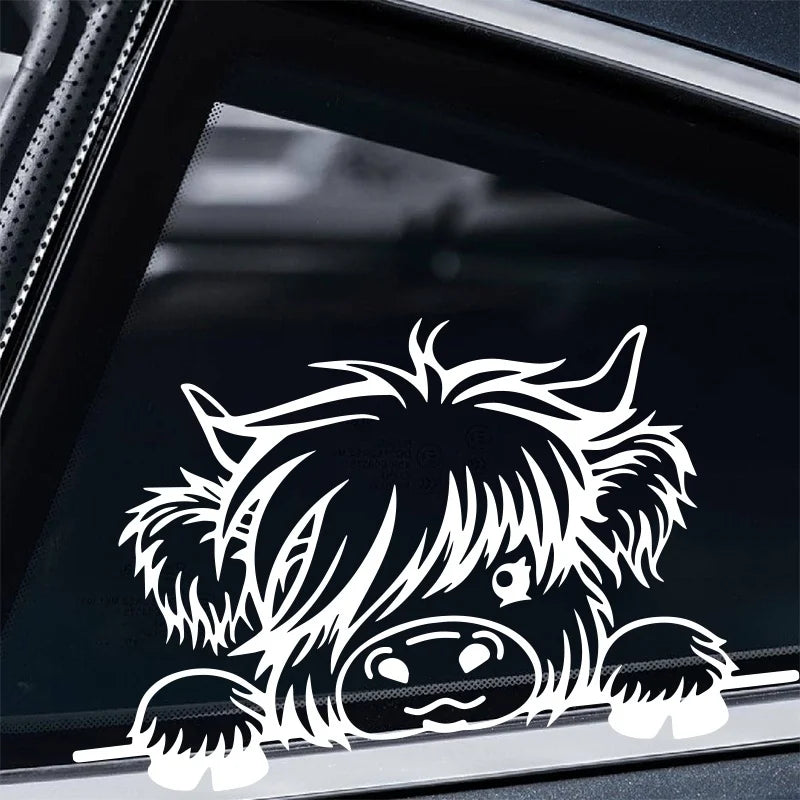 A black vinyl car sticker featuring a silhouette of a cow's head with shaggy hair.