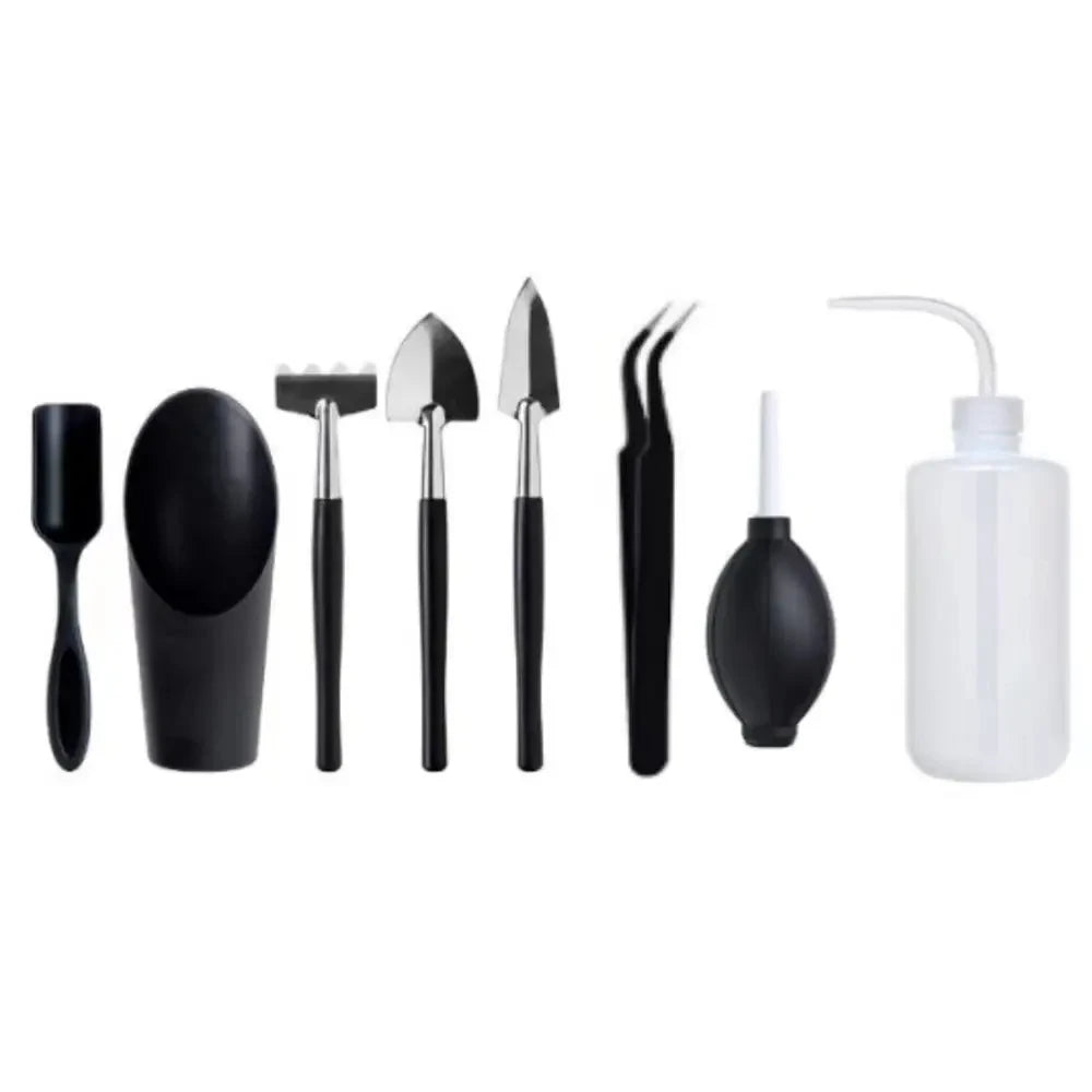 A set of black succulent and bonsai gardening tools including various small hand tools and a spray bottle.
