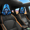 A pair of blue glowing skull headrest covers accenting the interior of a car seat.