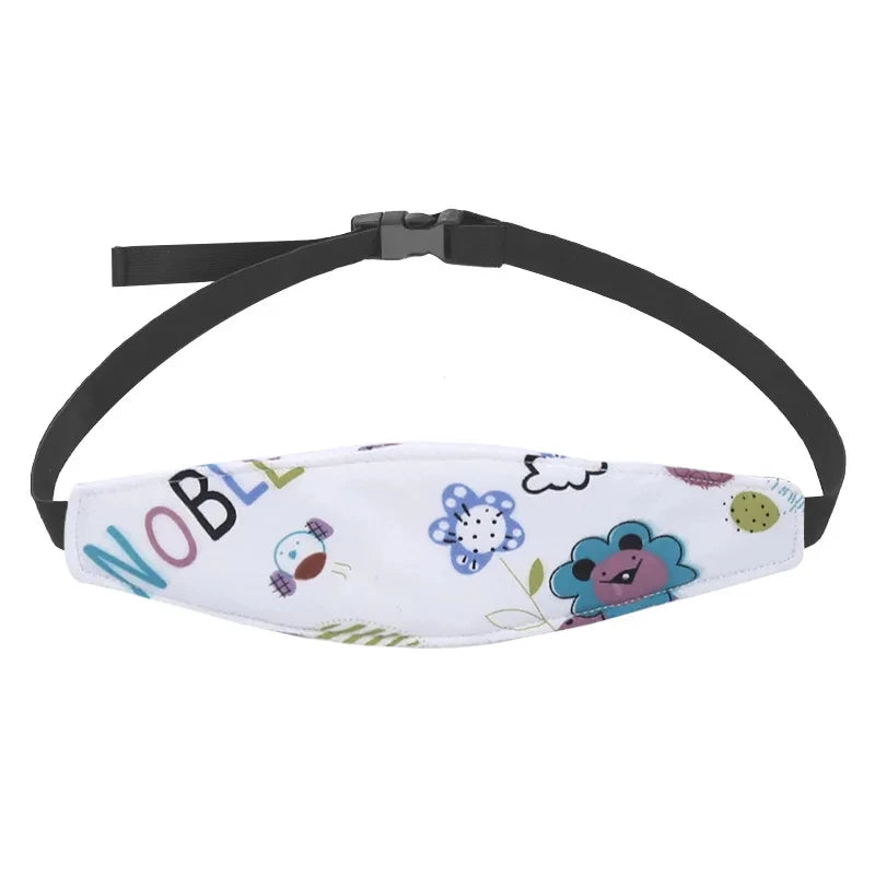 A white baby car seat sleeping headrest with a black adjustable belt strap and cute cloud patterns.