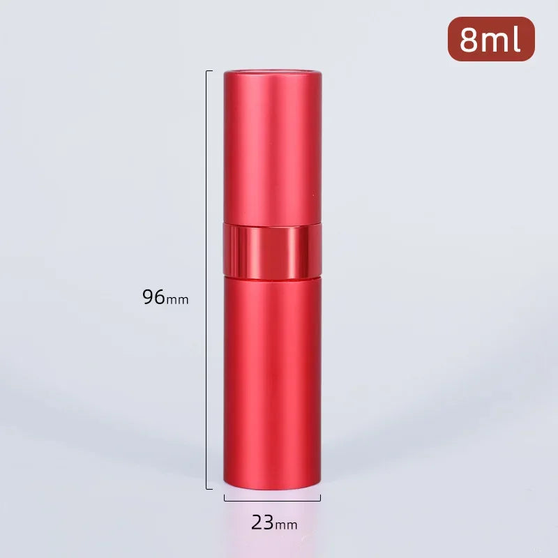 A vertical shot of a red aluminum perfume atomizer bottle with a silver cap and a black measuring line.