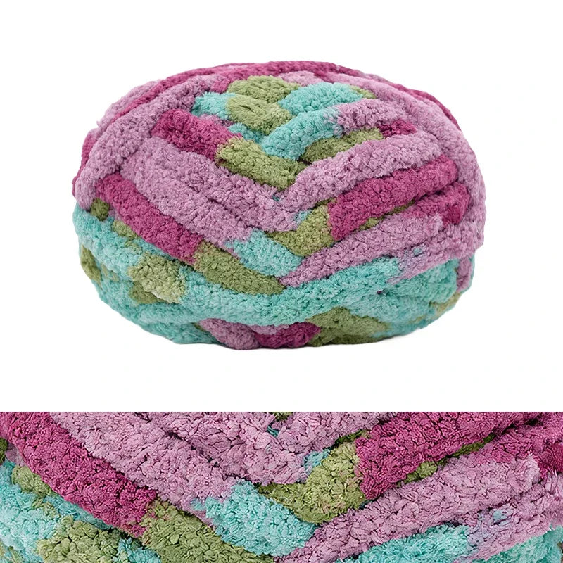 A ball of chunky chenille yarn in shades of pink, purple, and green.