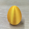 A smooth, golden egg shaped like a funny middle finger Easter egg desk decor.