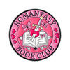 Pink enamel pin featuring a pink butterfly and a silver sword above an open book with a pink heart design.