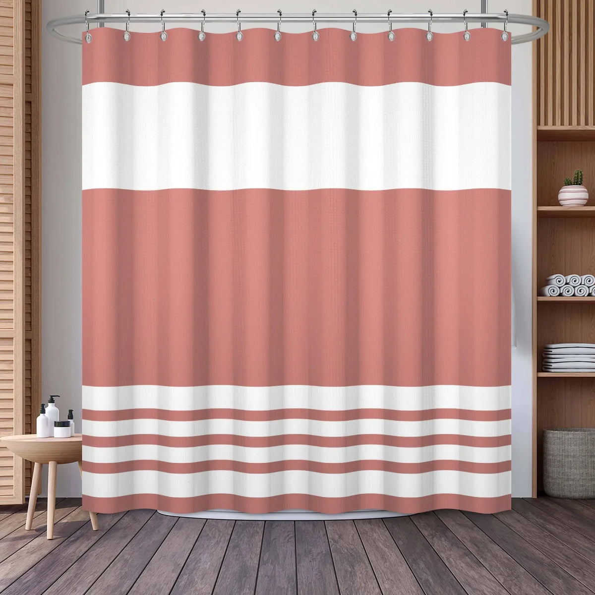 A shower curtain featuring a vertical geometric stripe pattern in shades of pink and white.