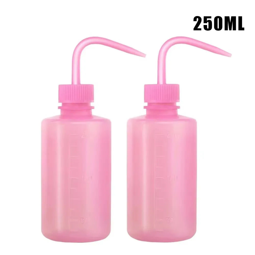 Two pink tattoo squeeze bottles with precision tips, labeled 250ml.