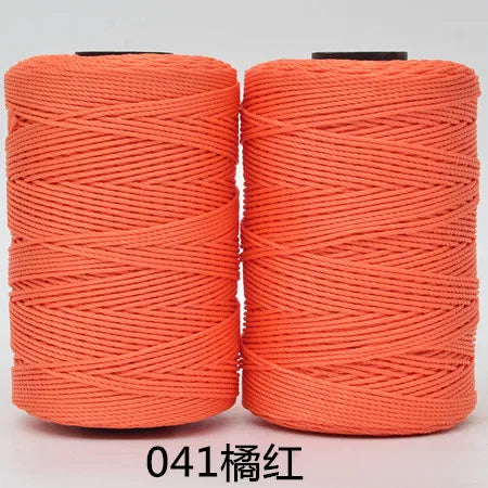 Two spools of orange 3-ply polyester knitting yarn for crochet and hand crafts