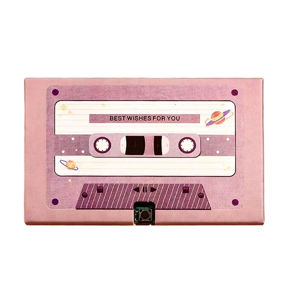A pink recordable voice greeting card with a cassette design featuring stars and planetary symbols.