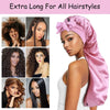 A model wears a pink satin sleep bonnet with an adjustable tie, highlighting its silky texture and fit.