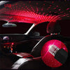 Interior car cabin illuminated by red LED light projection resembling a starry sky