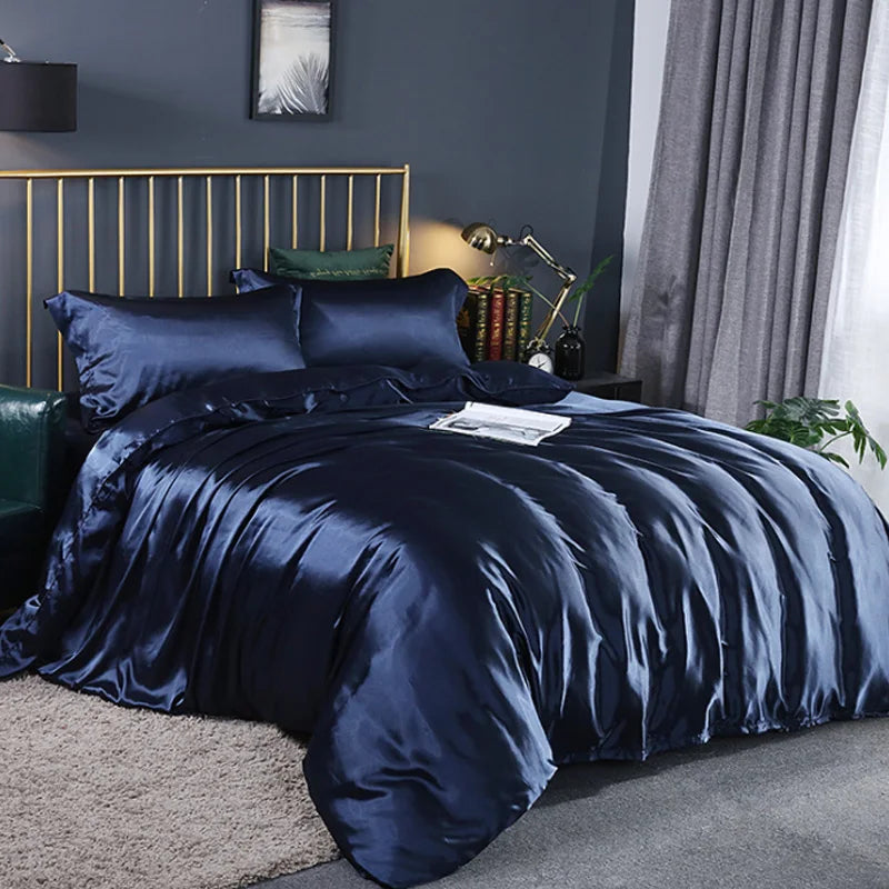 A dark navy blue silky duvet cover set with corner ties and zipper displayed on a bed.