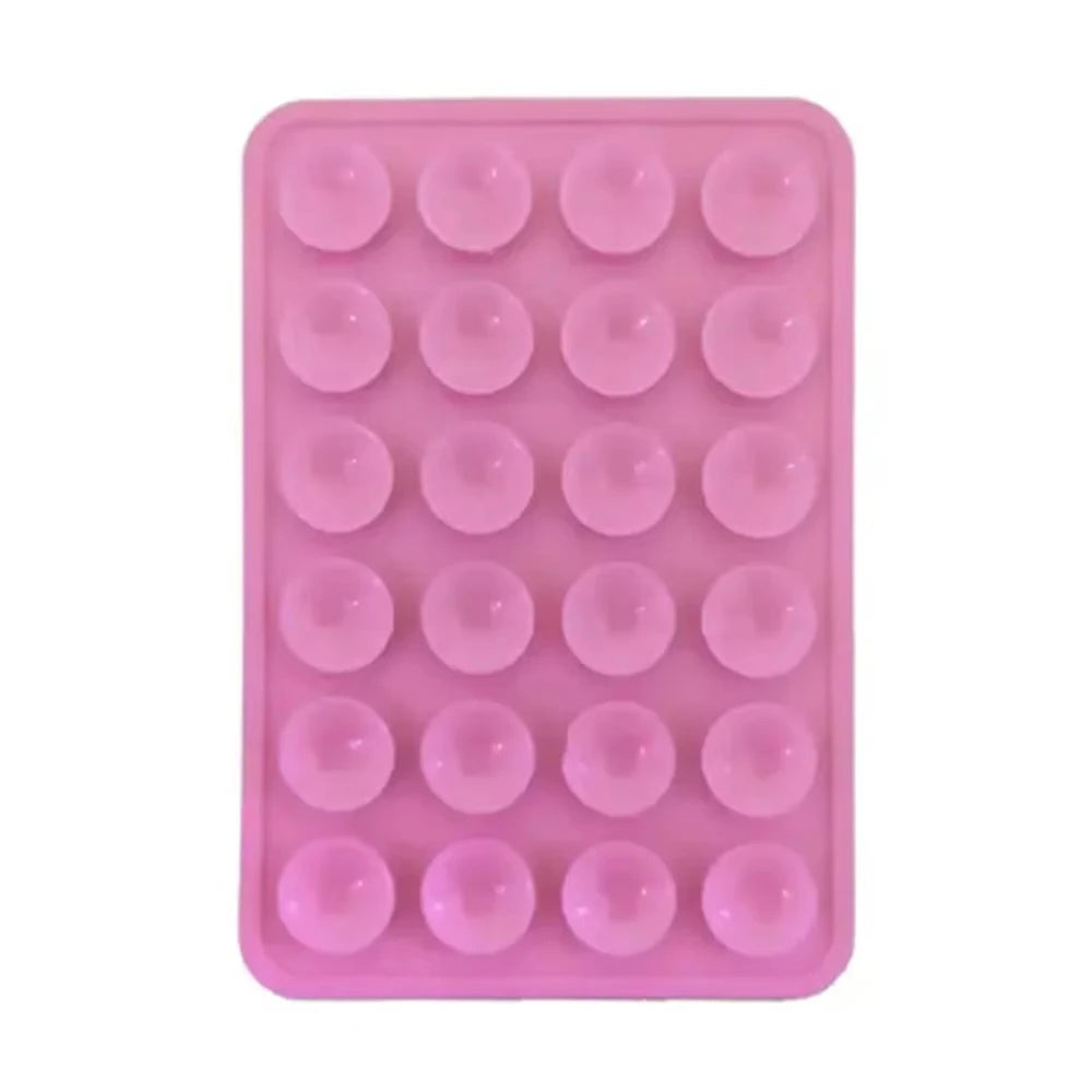 A pink reusable silicone suction cup phone mount for hands-free viewing with multiple suction cups.