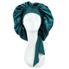 A dark teal satin sleep cap draped over a white mannequin head.