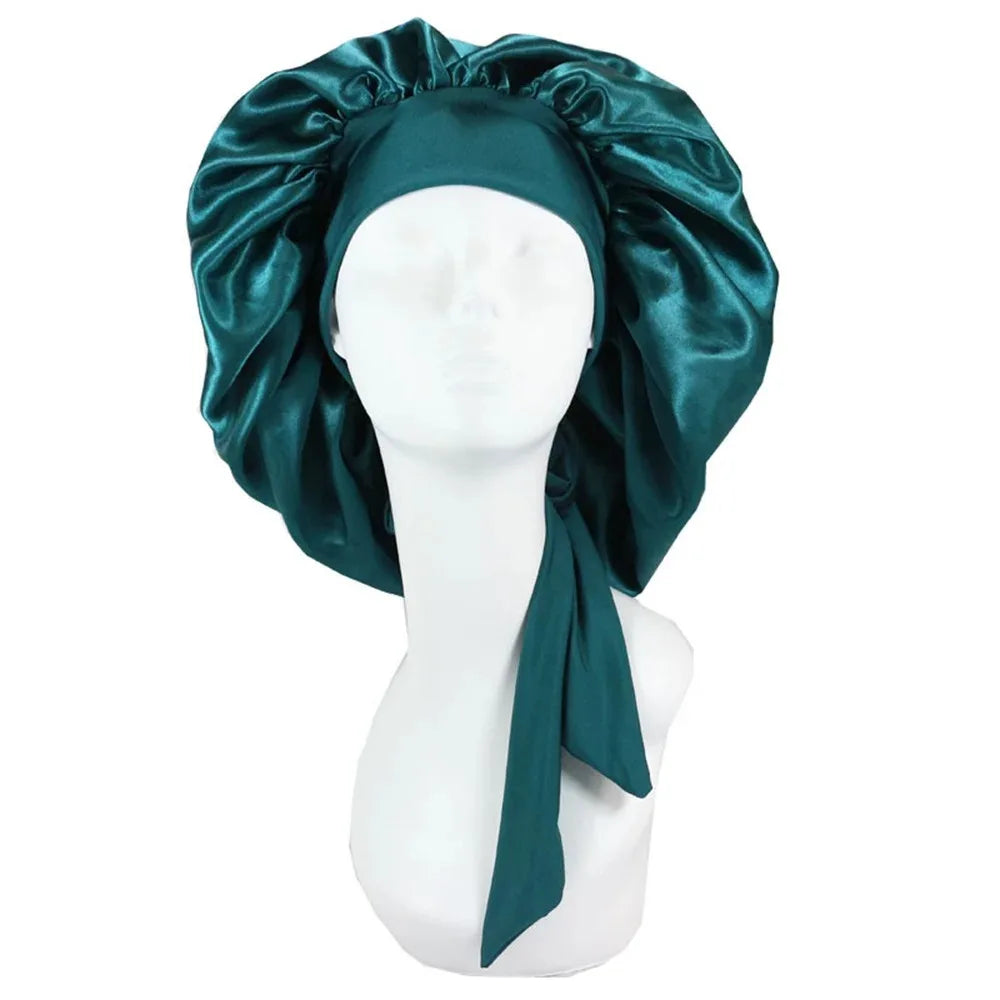 A dark teal satin sleep cap draped over a white mannequin head.