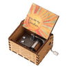 A hand-cranked wooden music box featuring a sunburst design and the text You are my Sunshine.