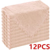 A stack of six raw-edge, light pink polyester cloth napkins.