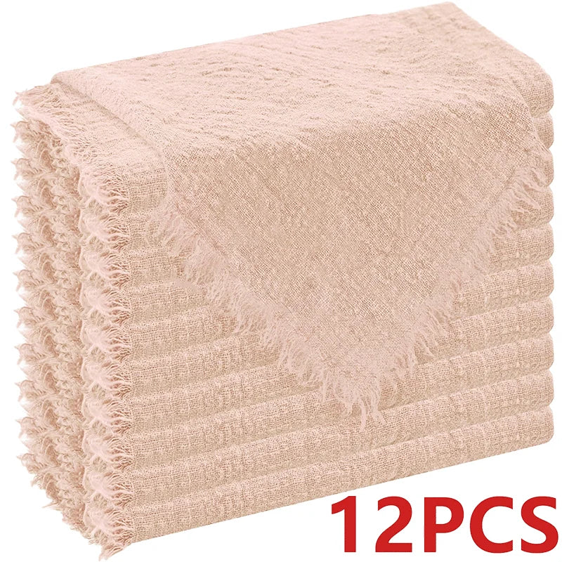 A stack of six raw-edge, light pink polyester cloth napkins.