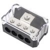 A black car audio power distribution block with clear plastic housing and four fuse holders.