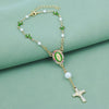 Gold rosary necklace with white pearls and green accents featuring a car pendant.