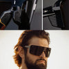 A close-up of black UV400 polarized sports sunglasses being worn by a man with a beard.