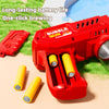 A red bubble gun is shown with yellow cartridges on a grassy outdoor surface.