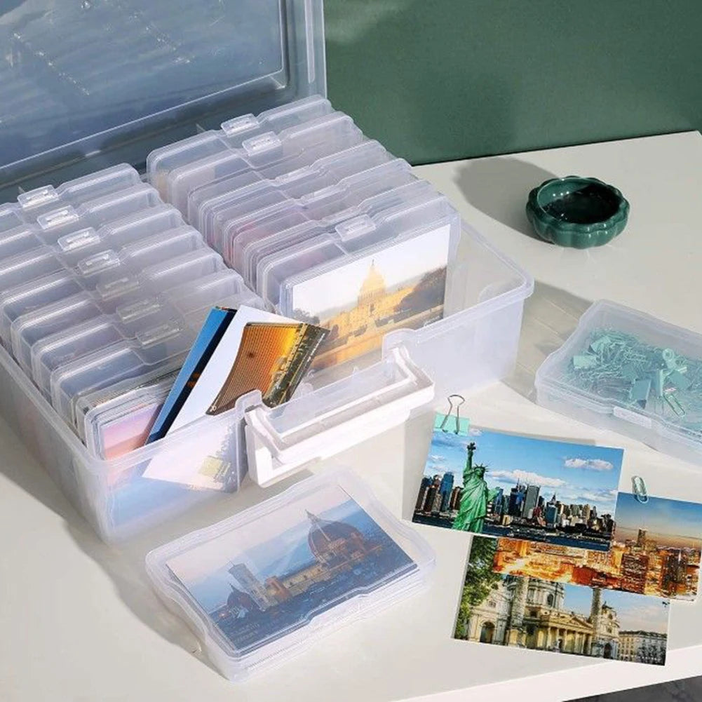 Clear plastic storage boxes filled with 4x6 photos and prints are displayed on a white surface.