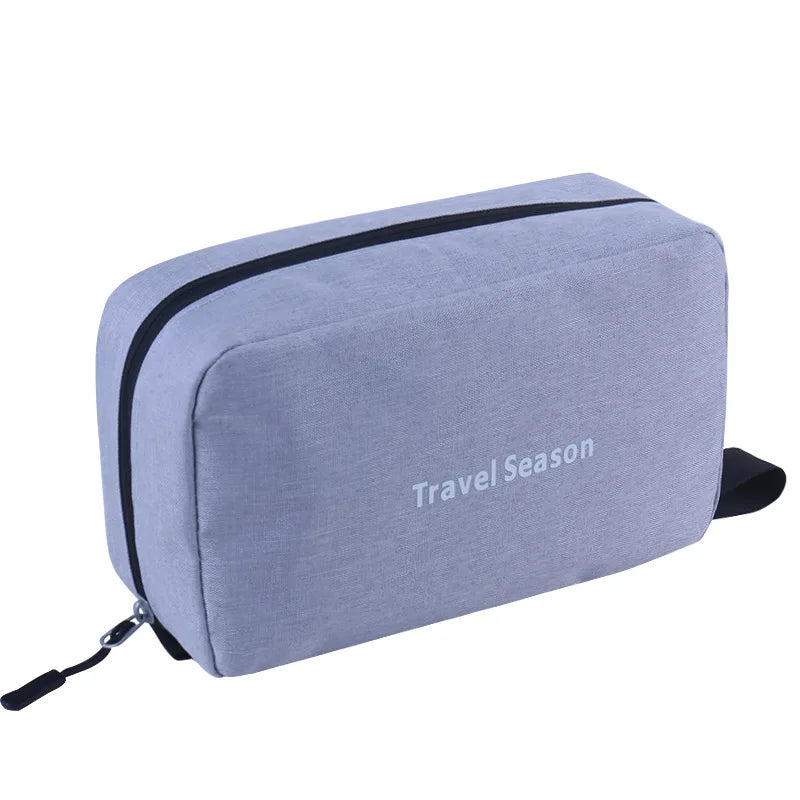 A light gray hanging toiletry bag with a black stripe and strap.