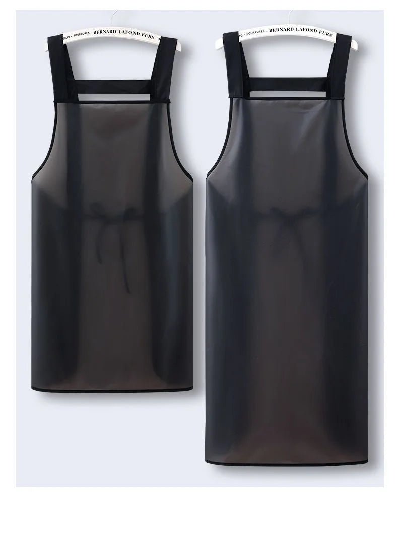 A black waterproof kitchen apron hanging on a hanger.