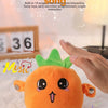 An orange fruit-shaped plush toy is being gently touched by a hand, set against a soft, white background.