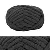 A ball of dark gray chunky chenille yarn for hand knitting and crochet