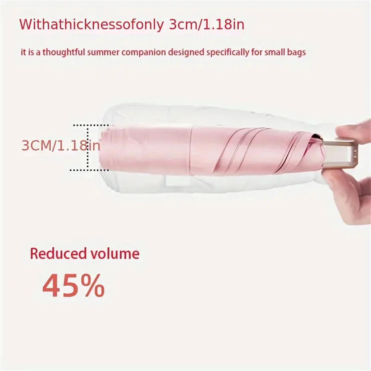 A pink folding umbrella is shown next to a white bag, highlighting its thinness and reduced volume.