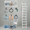A collection of heavy-duty nylon cord organizer straps and a white ladder displayed against a gray concrete wall.