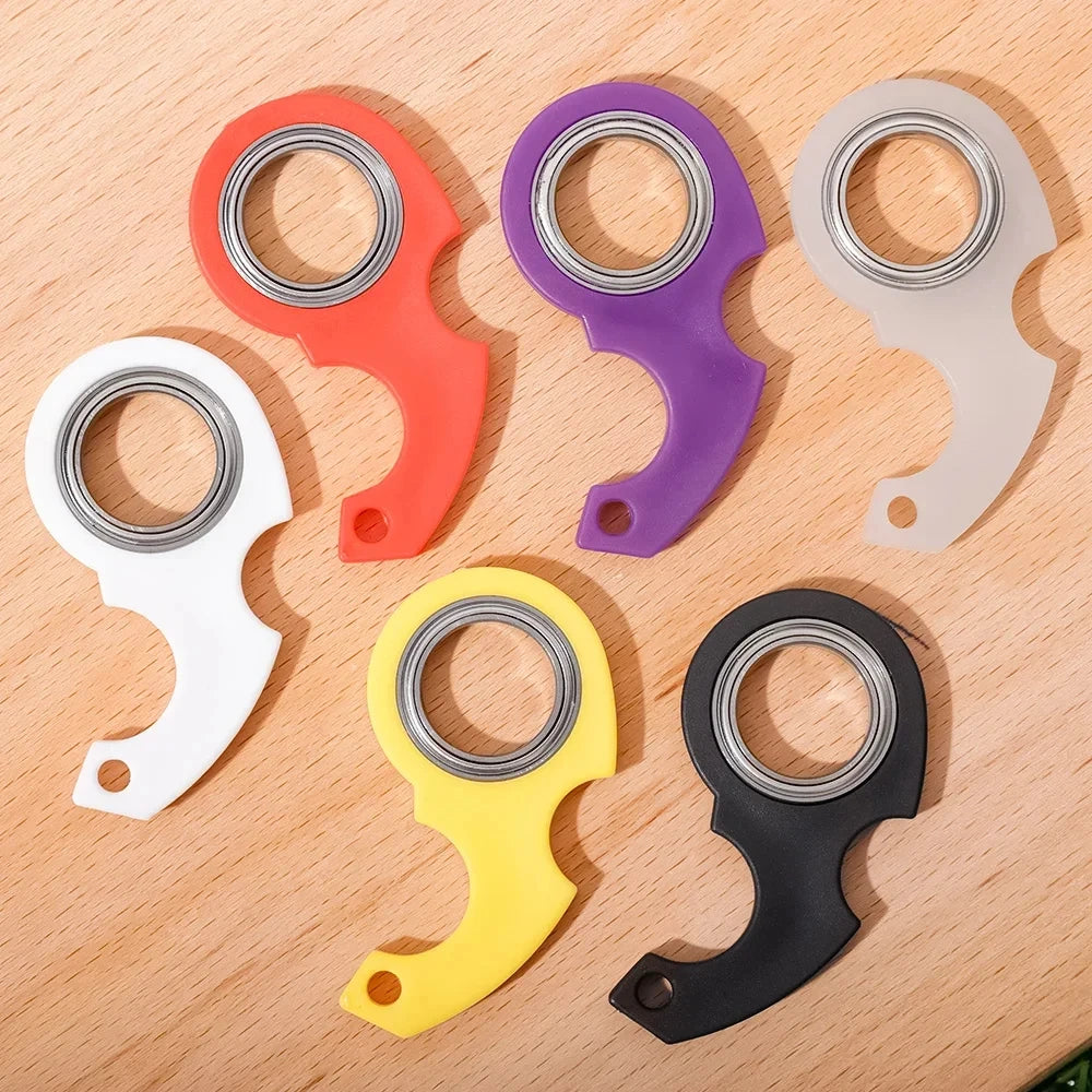 A collection of eight metal fidget spinners in various colors including red, purple, silver, white, and yellow, arranged on a