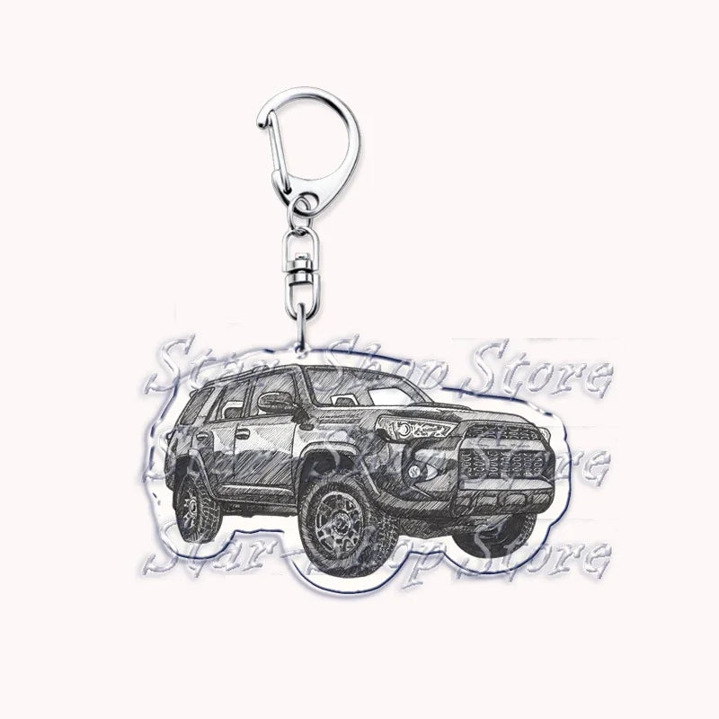 A silver metal key ring attached to a miniature model of an off-road truck.