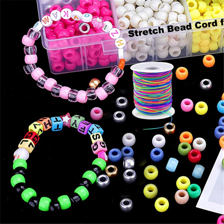 Assortment of colorful elastic bead cords and components for jewelry making including pink, white, yellow, and green beads.