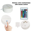 A sixteen-color cracked base night light with a remote control and a wall plug.