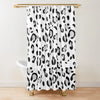 A white shower curtain featuring a black and gray leopard print pattern hanging from a gold rod.