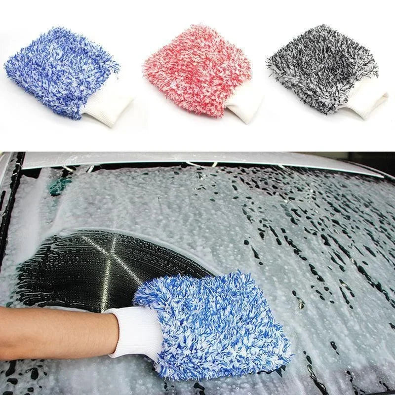 A hand is using a blue microfiber car wash mitt on a wet car surface for detailing.