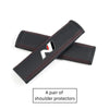 A pair of black PU leather shoulder protectors for car headrests and seatbelts