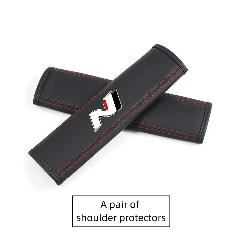 A pair of black PU leather shoulder protectors for car headrests and seatbelts