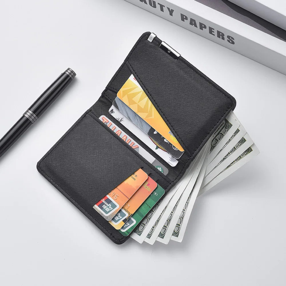 A black slim vertical leather wallet for men is shown open, displaying various cards and banknotes on a white surface.