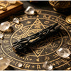 A black willow wood wishing stick resting on an antique brass zodiac chart with crystals.