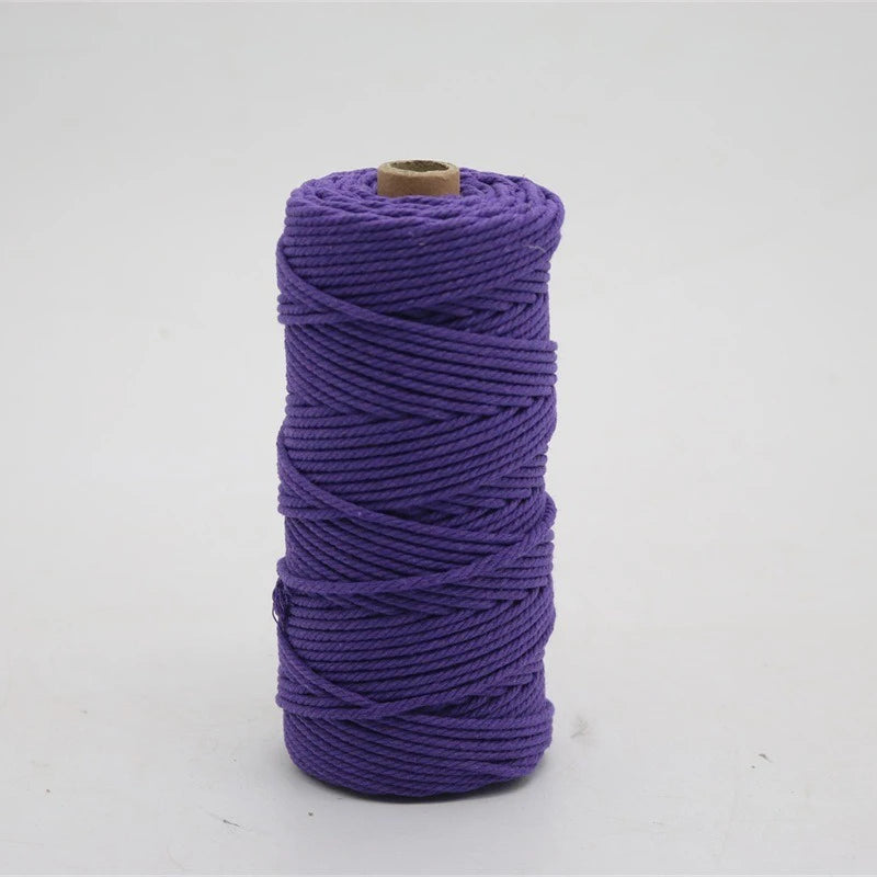 A spool of purple macrame cord, 3mm/4mm thickness, used for crafting.