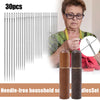 A set of 30 needle-free household sewing needles with wooden storage cylinders shown next to an elderly woman.