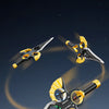 A black and yellow RC stunt aircraft is shown in flight against a mountainous background.