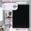 Solid black waterproof PEVA shower curtain hanging on a rod with stainless steel eyelets.